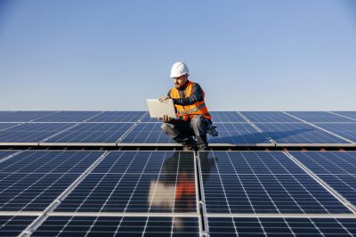 Technician Installing Solar Panels